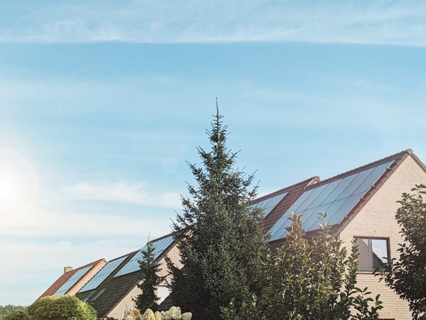 a row of houses with solar panels on the roof